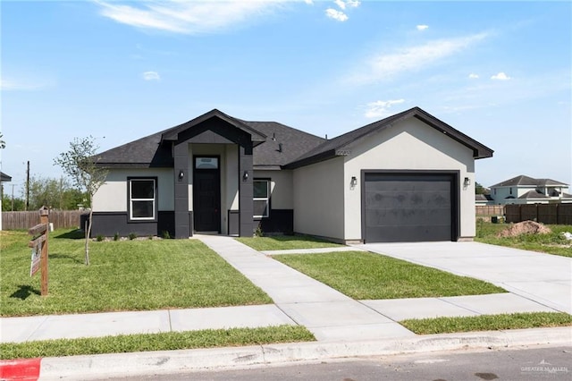 2203 San Charbel St, San Juan, TX 78589 - view of front of home with stucco siding, fence, a front lawn, an attached garage, and concrete driveway