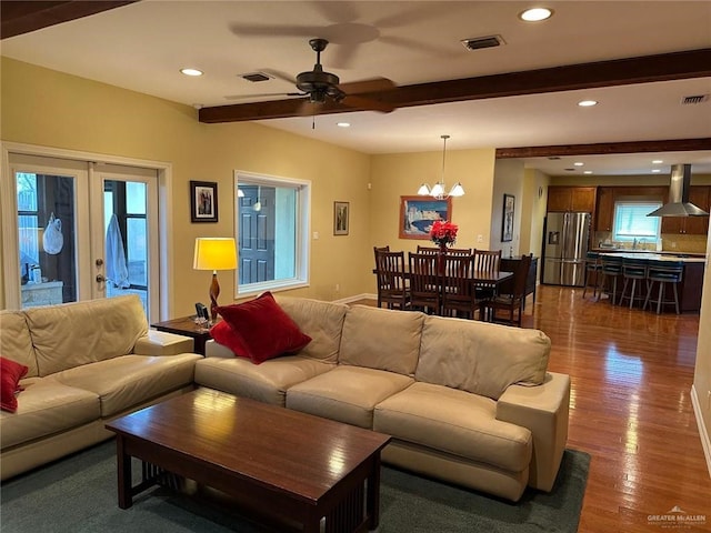 living room featuring recessed lighting, visible vents, french doors, dark wood-style floors, and beamed ceiling