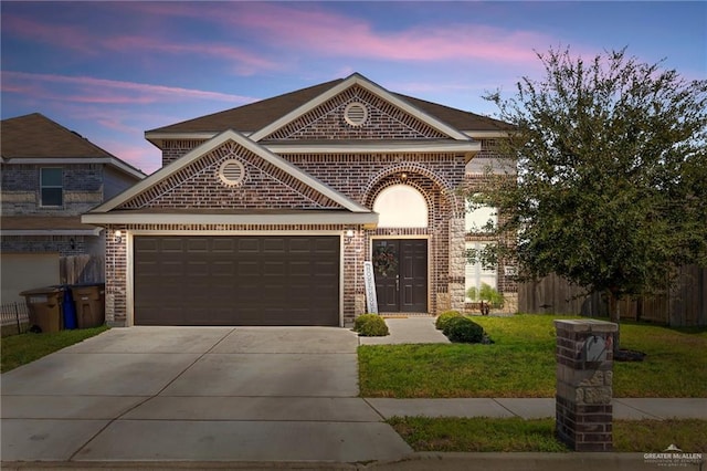 view of front of property featuring fence, driveway, an attached garage, a lawn, and brick siding