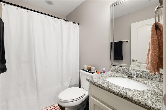 bathroom featuring toilet and vanity