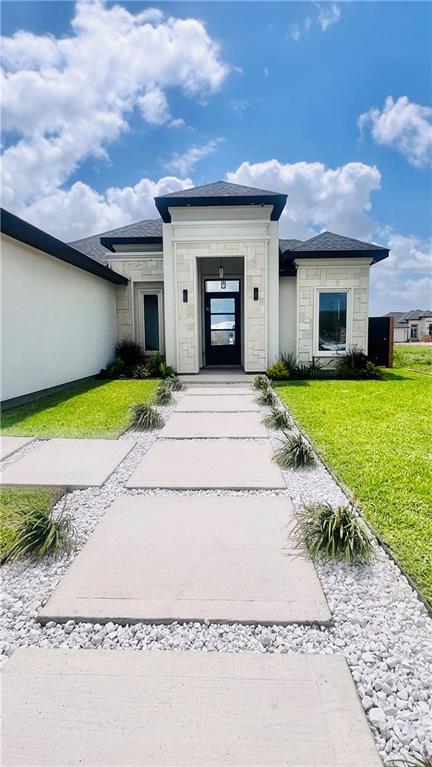 8104 N 51st St N, Mcallen, TX 78504 - view of front of property with a front yard and stone siding