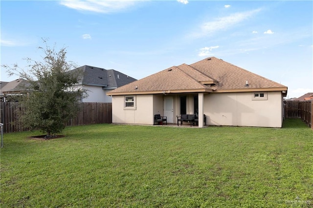 back of house with a yard, roof with shingles, a fenced backyard, and stucco siding