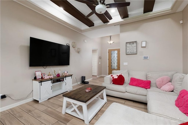 living area with ceiling fan, wood finish floors, and baseboards