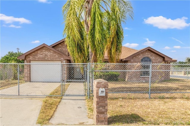 2407 Flores Dr, Mission, TX 78574 - view of front of house with brick siding, a gate, driveway, and fence
