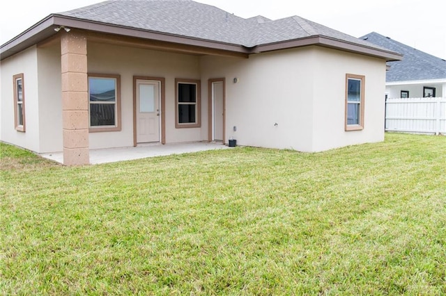 back of house featuring a yard and a patio