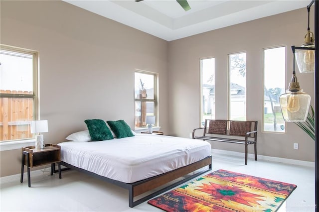 bedroom with ceiling fan and multiple windows