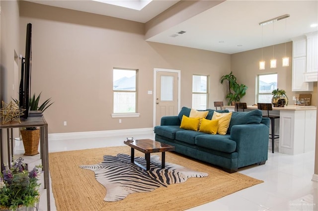 living room with a wealth of natural light and light tile patterned floors