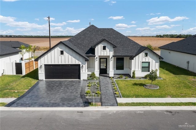 3404 Saint Honore Dr, Mcallen, TX 78504 - modern inspired farmhouse with a garage, a front lawn, board and batten siding, and a shingled roof