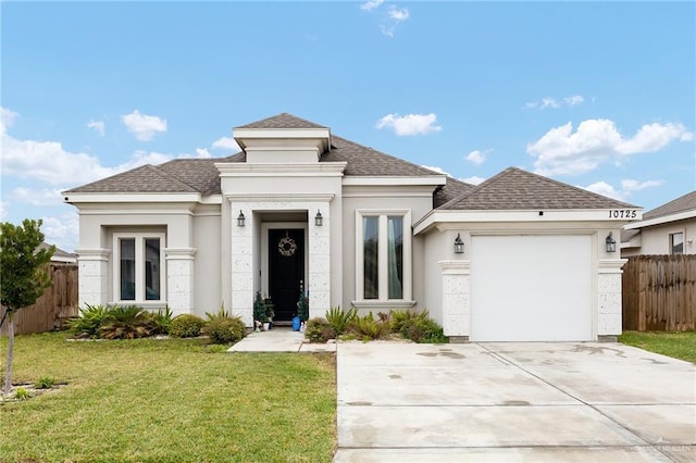 view of front facade with a garage and a front lawn