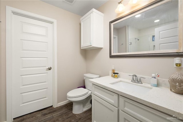 bathroom featuring vanity, an enclosed shower, and toilet