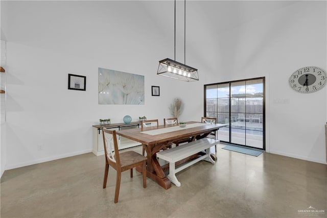 dining area with a towering ceiling