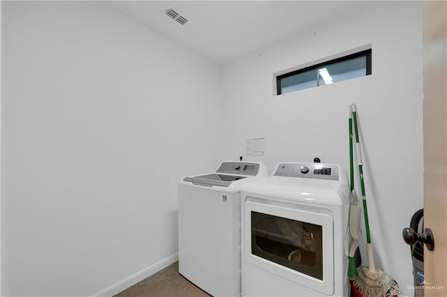 clothes washing area featuring independent washer and dryer