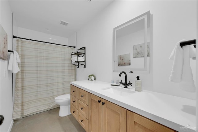 bathroom featuring vanity, toilet, and curtained shower