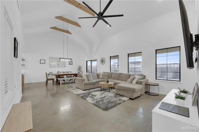 living room featuring ceiling fan and a towering ceiling