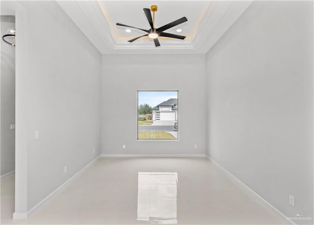 spare room with baseboards, a ceiling fan, a tray ceiling, crown molding, and recessed lighting