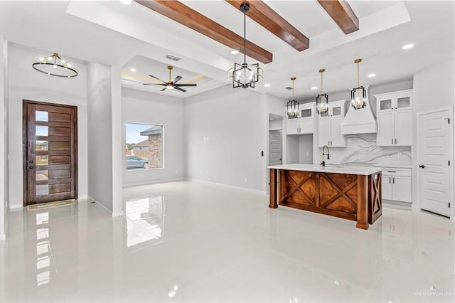 kitchen featuring visible vents, decorative backsplash, beamed ceiling, light countertops, and a sink