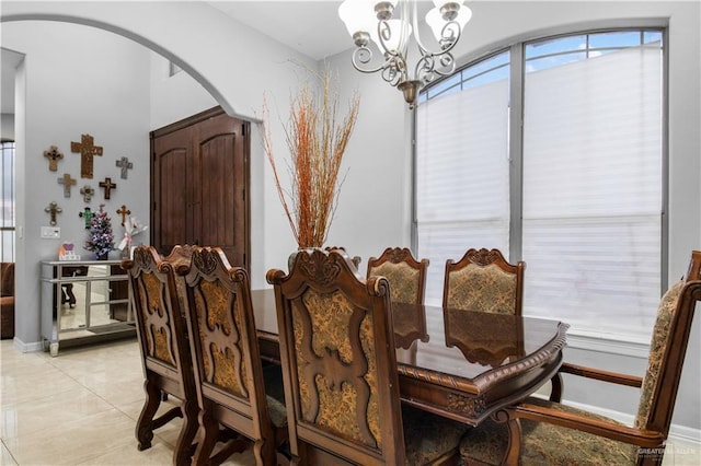 tiled dining space with a notable chandelier