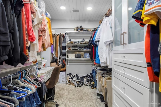 walk in closet featuring carpet flooring