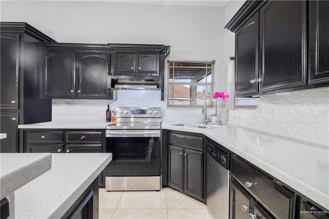 kitchen with light tile patterned flooring, appliances with stainless steel finishes, range hood, sink, and decorative backsplash