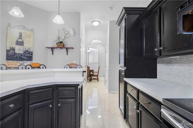 kitchen featuring pendant lighting, light tile patterned flooring, and backsplash