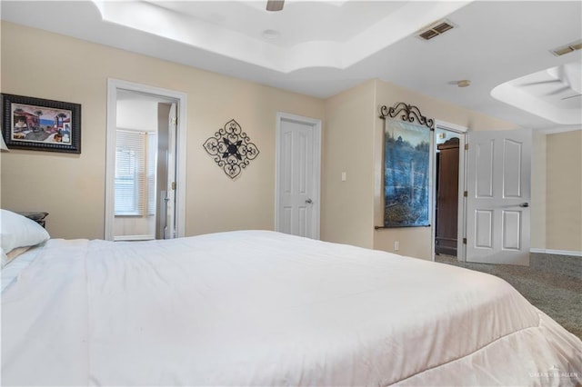 bedroom featuring a raised ceiling, carpet flooring, and ceiling fan