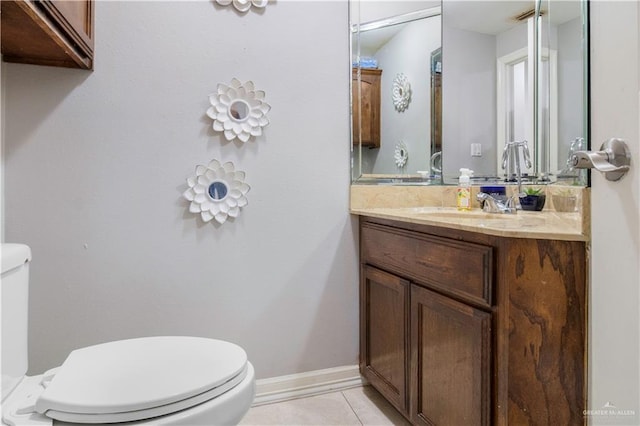 bathroom with vanity, tile patterned floors, and toilet