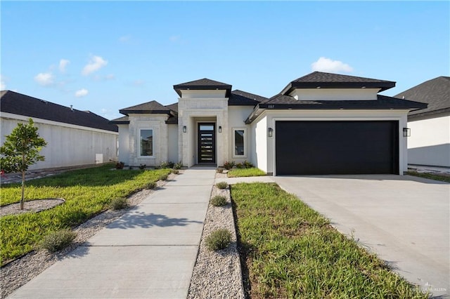 prairie-style home featuring a garage and a front yard