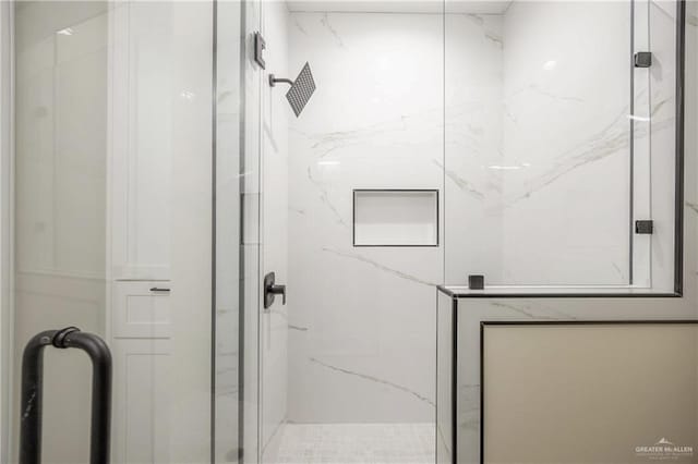 bathroom with a shower with door