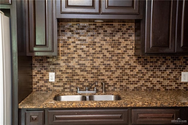 16877 Borchardt St, Harlingen, TX 78552 - kitchen with dark brown cabinetry, a sink, and backsplash