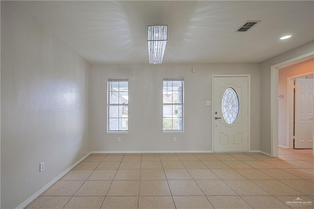 foyer entrance with light tile patterned floors