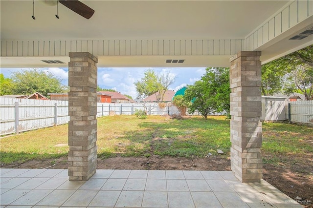 view of yard with a patio area and ceiling fan