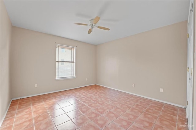 tiled empty room featuring ceiling fan