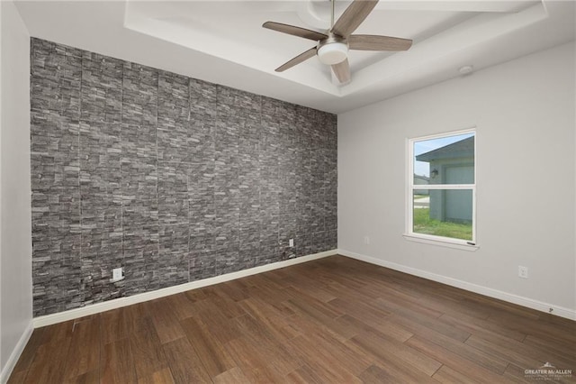 1421 Franklin Ave, Alton, TX 78573 - unfurnished room with a tray ceiling, a ceiling fan, wood finished floors, and baseboards