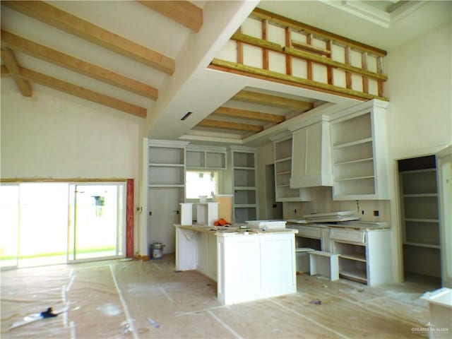 2701 E Versace Dr, Edinburg, TX 78542 - kitchen featuring beam ceiling, a kitchen island, and open shelves