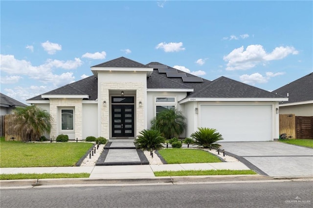 5904 N Dodger St, Pharr, TX 78577 - view of front of house with a garage, stone siding, roof with shingles, and driveway