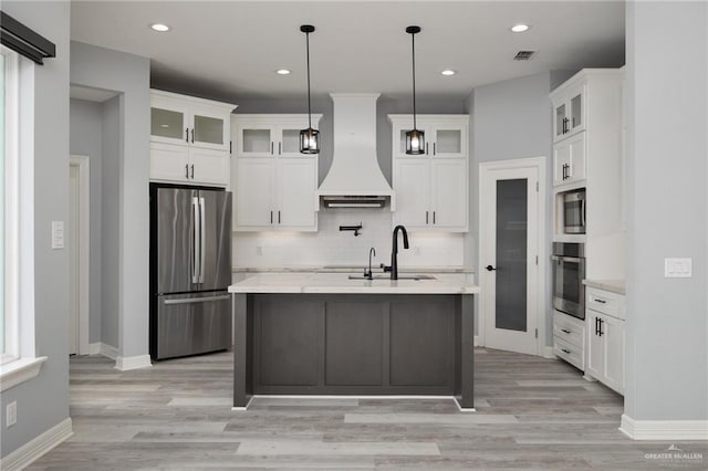 5904 N Dodger St, Pharr, TX 78577 - kitchen with appliances with stainless steel finishes, custom range hood, a sink, decorative backsplash, and white cabinetry