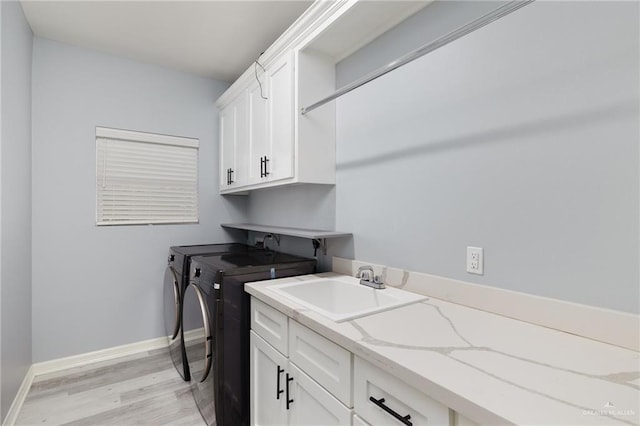 5904 N Dodger St, Pharr, TX 78577 - clothes washing area featuring cabinet space, washer and clothes dryer, light wood-style flooring, and baseboards