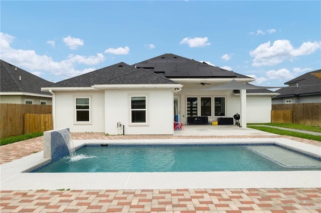 5904 N Dodger St, Pharr, TX 78577 - back of house with a patio, roof mounted solar panels, stucco siding, a fenced backyard, and roof with shingles