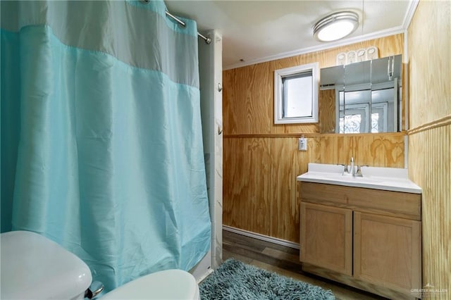 3204 Barbara Ln, Edinburg, TX 78542 - bathroom featuring toilet, vanity, wooden walls, and wood finished floors