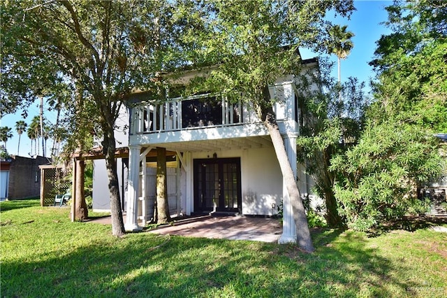 307 Bolivar Ave Unit 2, Rancho Viejo, TX 78575 - rear view of property featuring a lawn, french doors, and a patio area