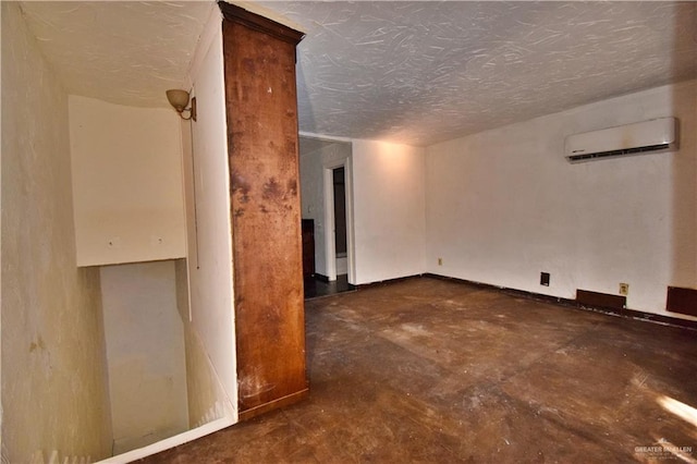 307 Bolivar Ave Unit 2, Rancho Viejo, TX 78575 - spare room featuring a textured ceiling and an AC wall unit