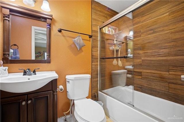 1301 Sonora St, Mission, TX 78572 - bathroom with vanity, toilet, enclosed tub / shower combo, and a textured wall