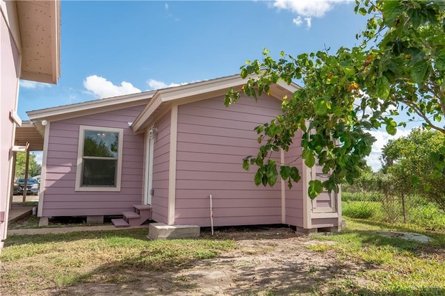 view of side of home with a yard