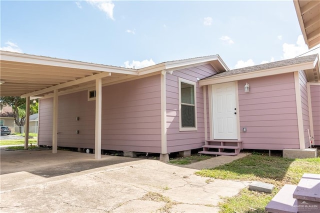 doorway to property featuring a carport