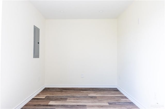 unfurnished room featuring wood-type flooring and electric panel