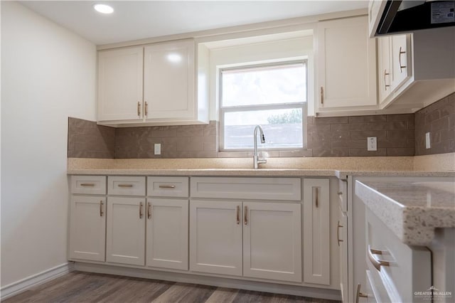 kitchen featuring white cabinets and extractor fan