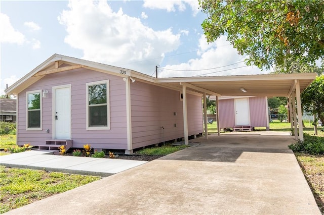 view of front of property featuring a carport