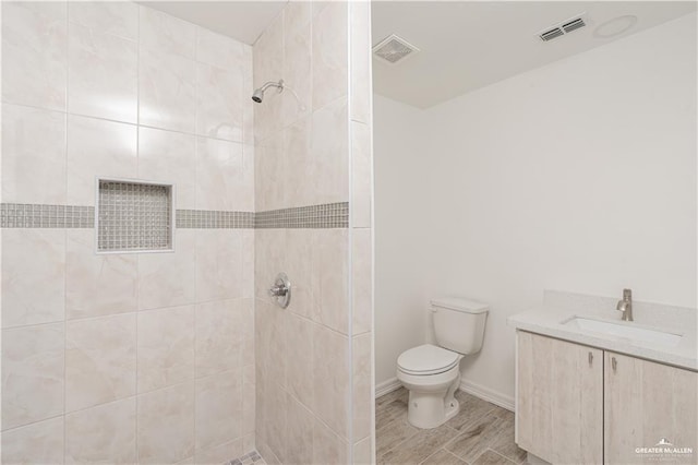 117 Keystone St, Mission, TX 78572 - full bathroom featuring toilet, a tile shower, vanity, and baseboards