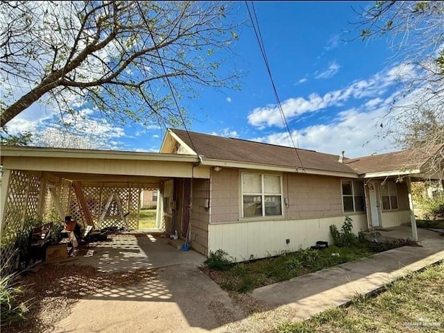 711 Marcos Hinojosa Ave, Hebbronville, TX 78361 - view of property exterior featuring a carport and driveway