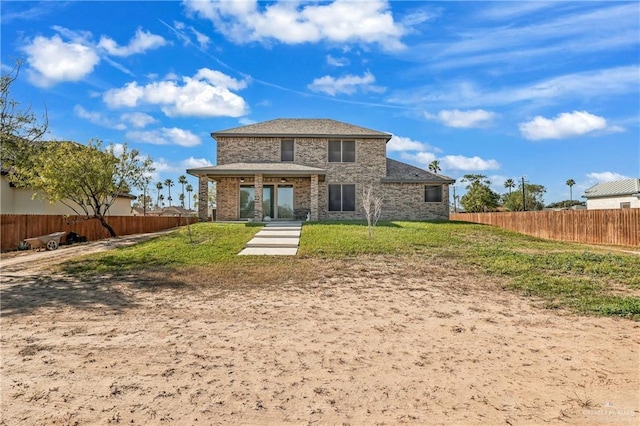 back of house featuring a lawn